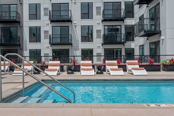 a swimming pool in front of an apartment building